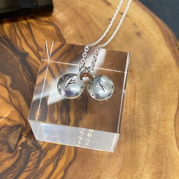 2 freya pendants in sterling silver by Susan Ohrn Jewelry presented on a lucite block