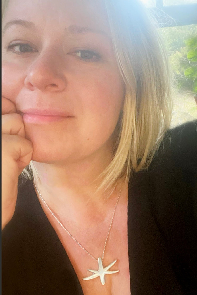 Astrid star pendant worn by Susan Popper of Susan Ohrn Jewelry